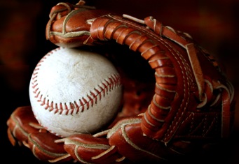 This photo of a baseball and baseball glove was taken by Miguel Ugalde, a native of Mexico City ... now Madrid, Spain.  Baseball is a sport loved the world over!
